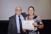 Dr. Nagib Callaos, General Chair, giving Mrs. Ariana Acon-Matamoros an award certificate in appreciation for his presentation oriented to inter-disciplinary communication entitled: "Analysis of Information in the Academic Management of the UNED, Required in the Self- Assessment Processes and the Relation Between Research and Design of the Investigation."